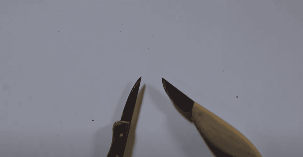 Alt text: A close-up view of two wood carving knives. One knife has a metal blade with a pointed tip, while the other has a slightly curved wooden handle and a sharp edge. Ideal for showcasing tools used in wood carving lessons and classes.